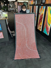 Load image into Gallery viewer, Artist Tansy Martin pictured holding her Bush Onion painting inside the Edwardstown gallery.