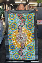 Load image into Gallery viewer, Justine Anderson in gallery holding her painting