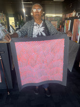 Load image into Gallery viewer, Maureen Hudson holding a piece of artwork sand dunes in coral and lilac colour