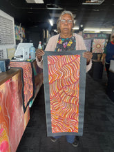 Load image into Gallery viewer, Maureen Hudson holding artwork in gallery