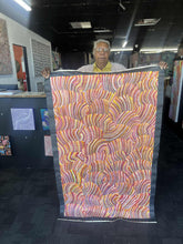 Load image into Gallery viewer, Maureen holding her painting "Sand Dunes"