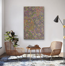 Load image into Gallery viewer, Belinda Golder Kngwarreye 154cm x 94cm My Country Living room with wicker chairs, a small table with chessboard, and a colorful abstract painting on the wall.