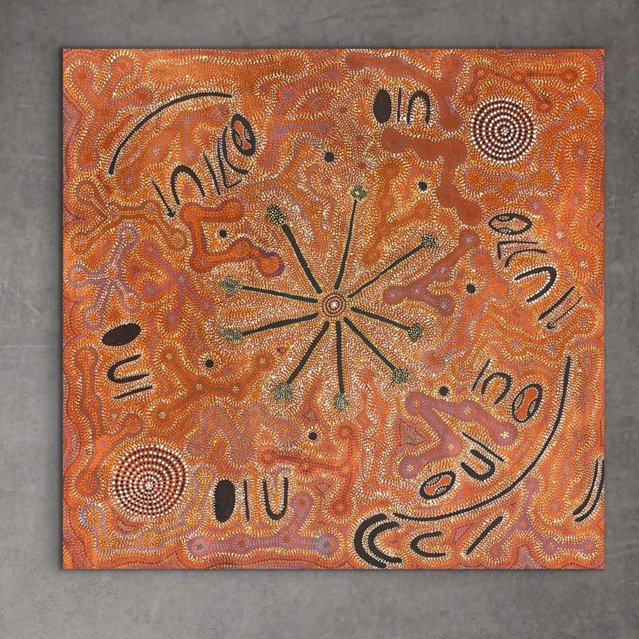 A piece of Aboriginal artwork featuring a central bushfire design with surrounding patterns and text. "Bushfire Dreaming" Selina Napaljarri Malbunka 83cm x 87cm