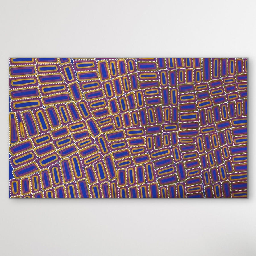 Tingari cultural Aboriginal story geoemtric shapes in yellow, red and vibrant ultramarine blue, with white dots displayed on white wall horizontal