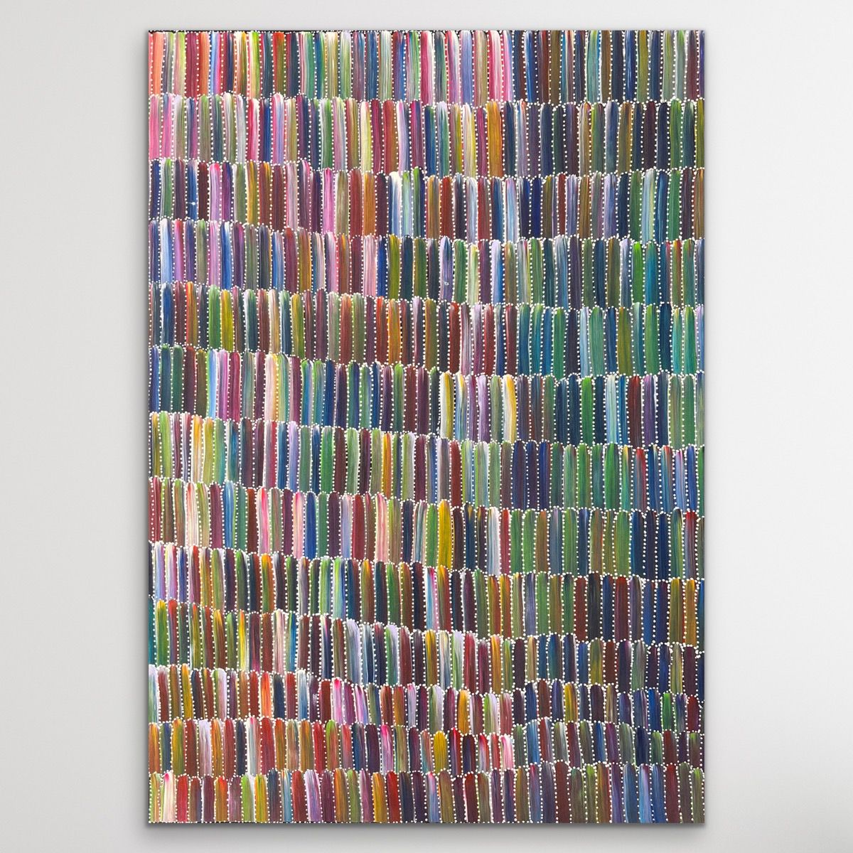 Multicolored yam dreaming painting on while wall