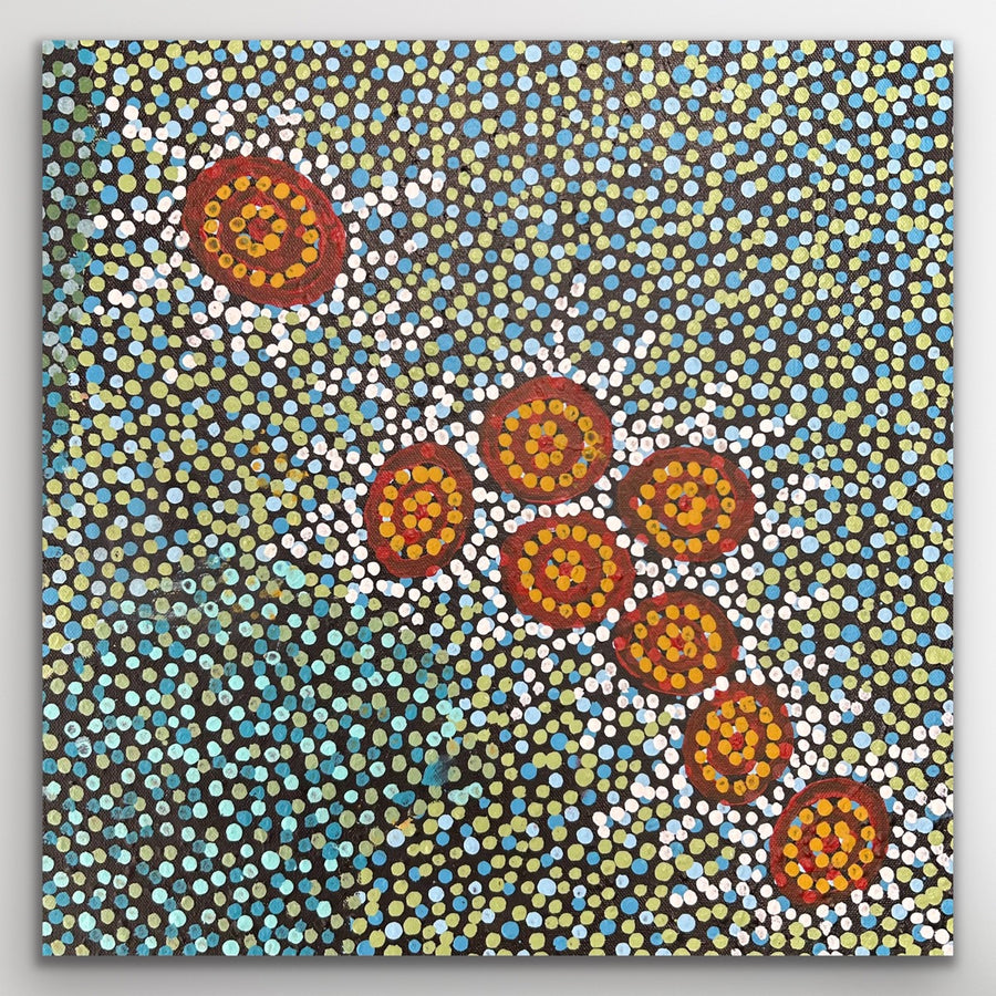 Dot painting with circular patterns in red, yellow, and blue on a textured background