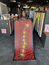 Load image into Gallery viewer, Artist Michelle Possum Nungurrayi photographed holding her Seven Sisters Dreaming canvas