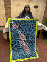 Load image into Gallery viewer, Artist Michelle Possum Nungurrayi holding Seven Sisters Dreaming, continuing the legacy of Clifford Possum Tjapaltjarri
