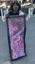Load image into Gallery viewer, Aboriginal artist Rhoda Tjitayi photographed holding her Piltati Tjukurpa artwork