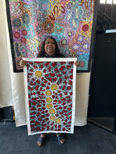 Load image into Gallery viewer, Aboriginal artist Michelle Possum Nungurrayi holding her Seven Sisters Dreaming painting
