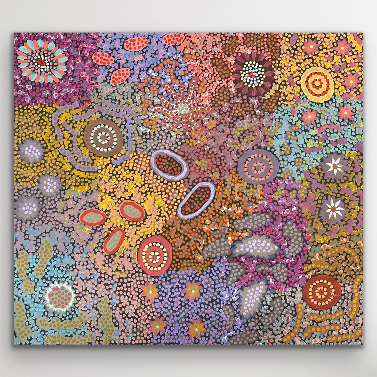 A vibrant mosaic of pink, gold and violet tones symbolising connection and harmony across Country.