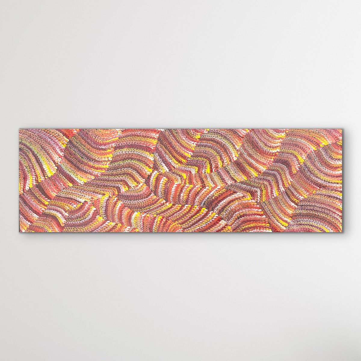 Sand Dunes painting orange, yellow and red displayed on white wall
