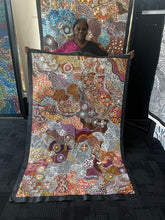 Load image into Gallery viewer, Janet Golder Kngwarreye from Utopia, Northern Territory, Australia holding her 180cm x 116cm painting &quot;( Utopia)My Country&quot; with orange, brown, white, black, cream, salmon, pink, yellows
