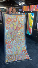 Load image into Gallery viewer, Julieanne Nungurrayi Turner holding her Budgerigar Dreaming painting in gallery 201cm x 87cm
