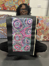 Load image into Gallery viewer, Rhoda Tjitayi holding artwork in gallery
