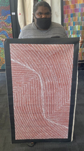 Load image into Gallery viewer, Artist Tansy Martin holding her Bush Onion Aboriginal painting in earthy tones with fine dot work
