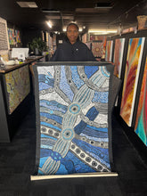Load image into Gallery viewer, Clarise holding her blue minima malilu artwork with lots of dot work and broad brush strokes
