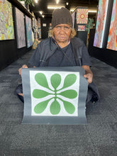 Load image into Gallery viewer, Debra Nangala McDonald with Mulga leaves painting. 
