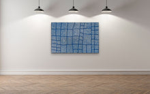 Load image into Gallery viewer, Abstract blue Aboriginal painting Tingari on a white wall with wooden flooring
