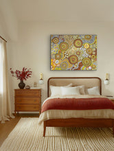 Load image into Gallery viewer, Bedroom with a wooden bed, red blanket, and colorful aboriginal painting on the wall.
