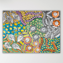 Load image into Gallery viewer, A colorful abstract floral painting with dense textured brushstrokes in turquoise, yellow, orange, green, purple, black, and white, shown hanging against a light gray wall.
