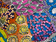 Load image into Gallery viewer, "Awelye" Karen Bird Ngale 98cm x 42cm mix of colorful patterns including pink and blue brushstrokes, purple and yellow floral motifs, black and white zebra-like lines, and orange textured areas.
