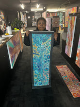 Load image into Gallery viewer, Photo of Bernadine Johnson Kemarre presenting her Bush Flowers painting in the Art by Farquhar Aboriginal Art Gallery, Edwardstown.
