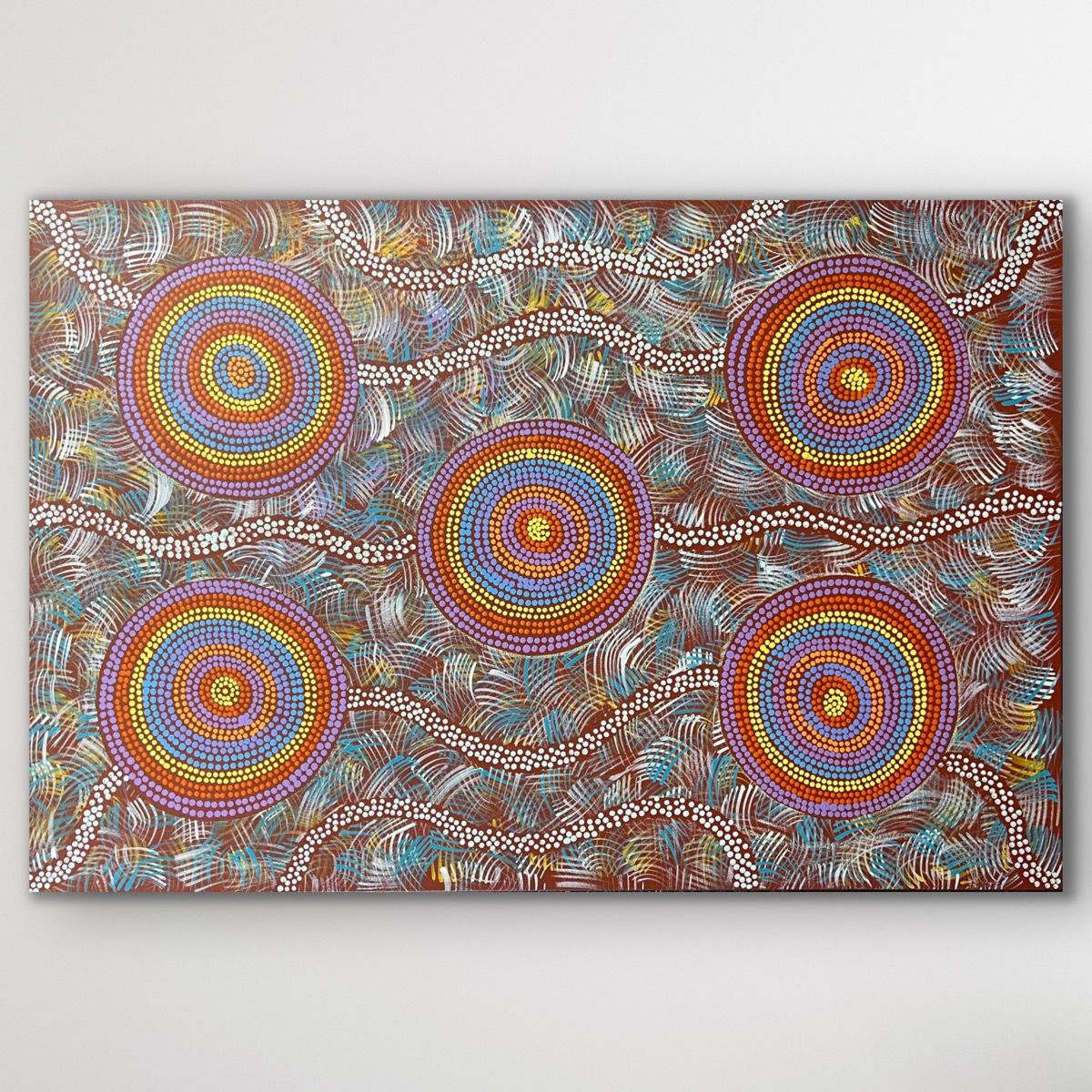 Rectangular painting showing the Budgerigar Dreaming story, featuring radiating circular forms and bright desert tones.