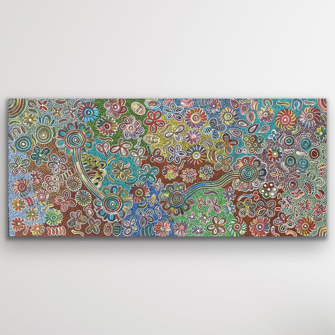Full view of Bush Flowers showing radiant pinks, greens and ochres arranged in circular floral motifs across the large canvas.