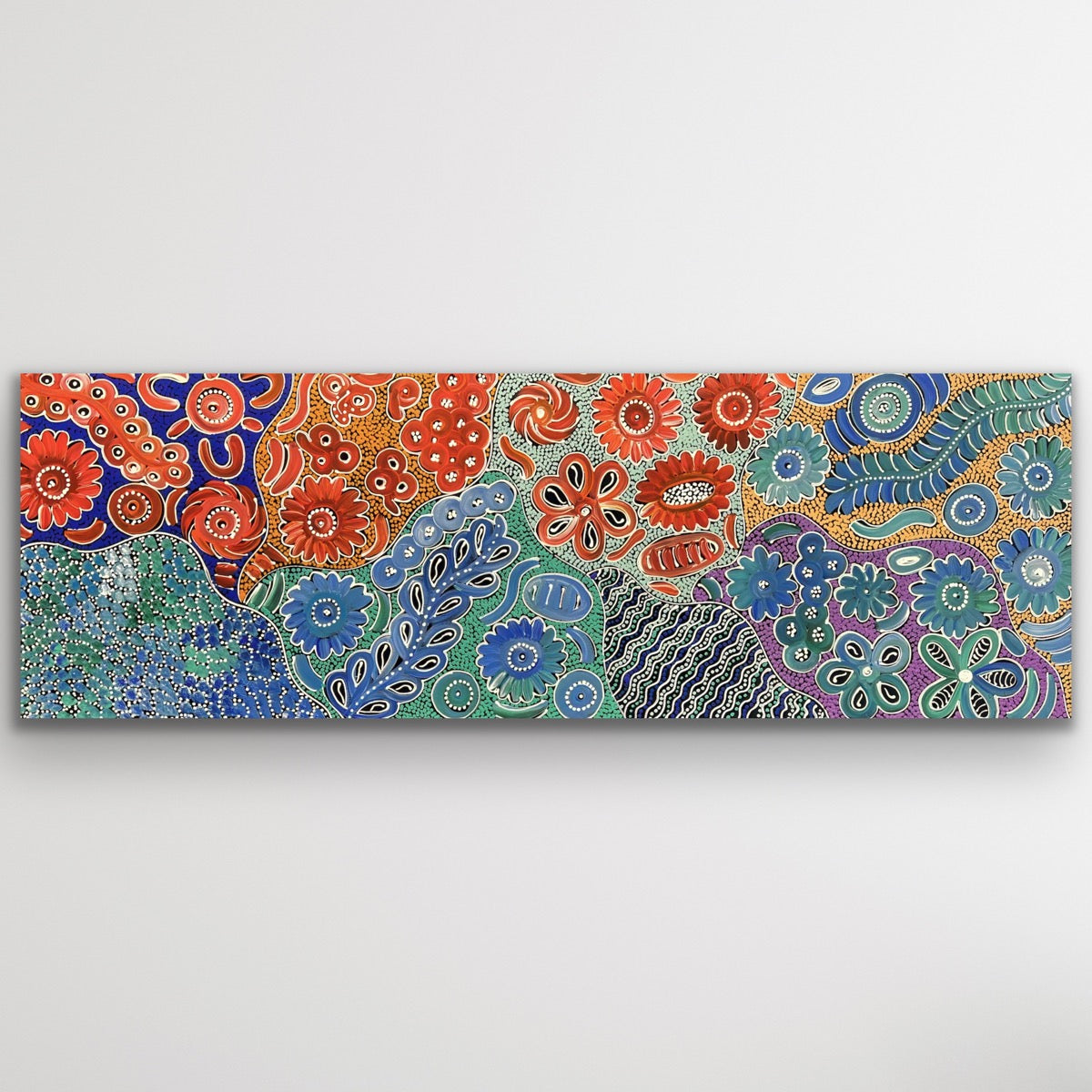 Bush Flowers Bloom Aboriginal print on canvas by Bernadine Johnson Kemarre displayed as wall art