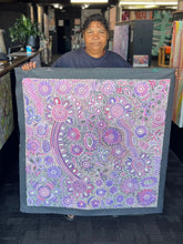 Load image into Gallery viewer, Bernadine Johnson Kemarre holding the Bush Flowers painting in the gallery showing scale, colour depth and overall composition.
