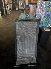 Load image into Gallery viewer, Aboriginal artist Nancy Martin Napangarti holding her Bush Onion painting
