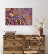 Load image into Gallery viewer, Clarise Tunkin art displayed on wall above drawers
