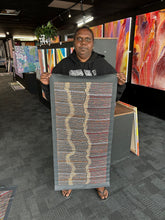Load image into Gallery viewer, Artist holding her Aboriginal Water Dreaming artwork on display
