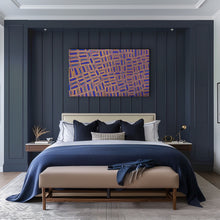Load image into Gallery viewer, Modern bedroom with dark blue paneled walls, a bed with blue and white bedding, and tingari aboriginal art above the bed.
