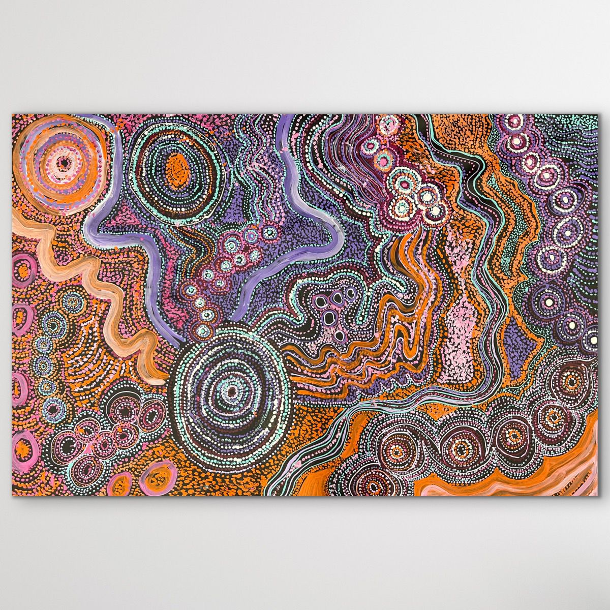 Colorful Indigenous artwork with swirling patterns on a white background