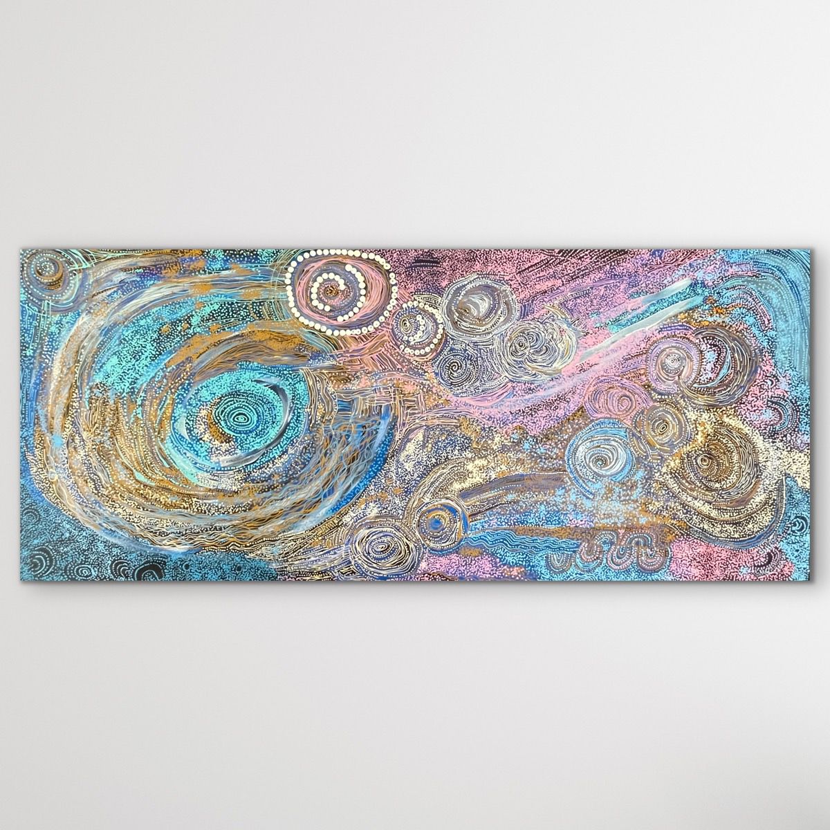 Large blue pink white cream yellow Aboriginal painting APY lands displayed on white wall