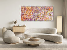 Load image into Gallery viewer, Modern living room with a textured sofa, round coffee table, and aboriginal painting on the wall. 
