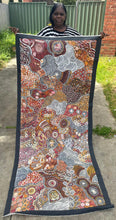 Load image into Gallery viewer, Artist Janet Golder Kngwarreye holding her My Country Utopia artwork, showing the scale of the piece.
