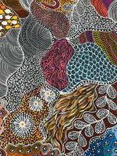 Load image into Gallery viewer, Artist holding her large Aboriginal painting &quot;My Country (Utopia)&quot; in a natural outdoor setting.
