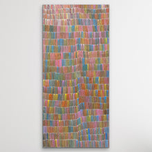 Load image into Gallery viewer, Yam Dreaming painting by Jeannie Mills Pwerle shown vertically on white wall with rainbow colours 213cm x 104cm
