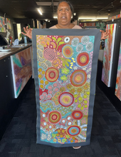 Load image into Gallery viewer, Artist Julieanne Nungurrayi Turner presenting her Budgerigar &amp; Bush Tucker painting inside Art by Farquhar Aboriginal Art Gallery, Edwardstown.
