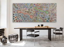 Load image into Gallery viewer, Dining room with a large aboriginal painting on the wall above a table.
