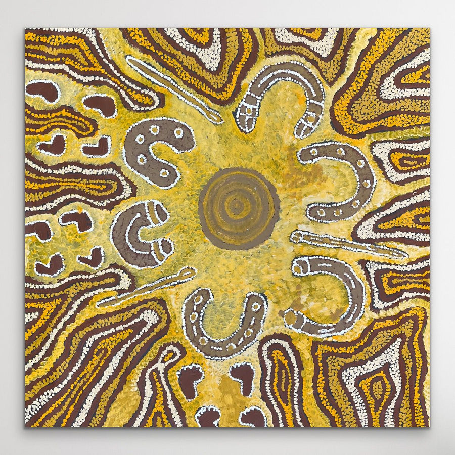 Indigenous piece with circular patterns in brown, yellow, and white on a gray background