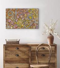 Load image into Gallery viewer, Aboriginal Art above a wooden dresser with a chair and vase.

