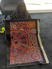 Load image into Gallery viewer, Artist photo of Audrey Brumby holding painting "Nguru Munu Tjukula" 90cm x 60cm
