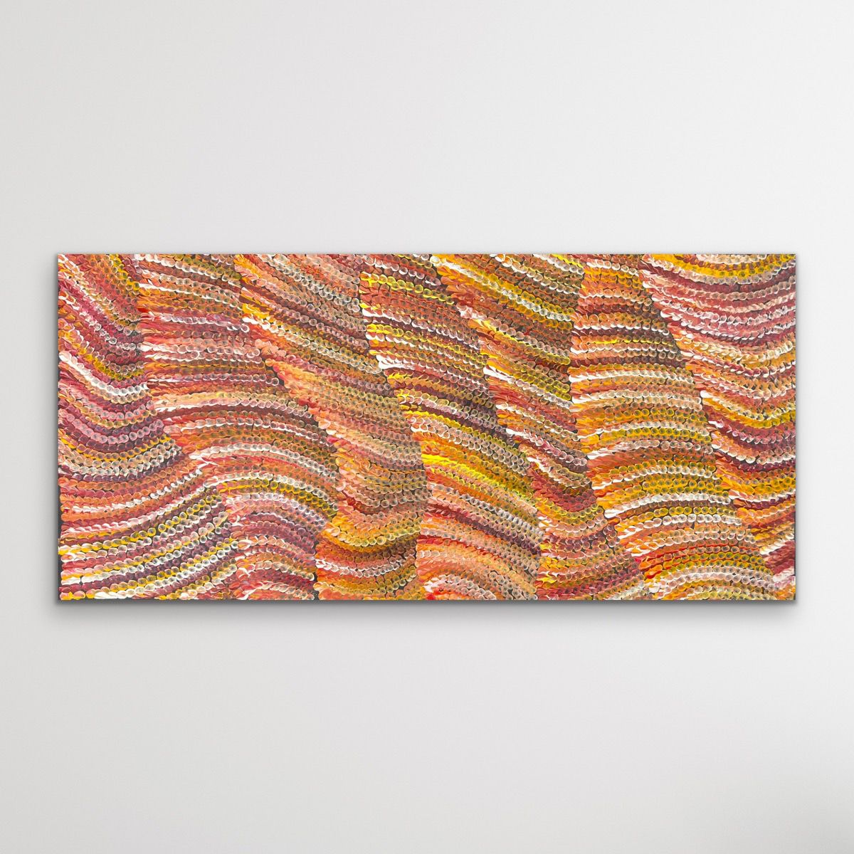 Aboriginal art piece with wavy patterns in warm on black background