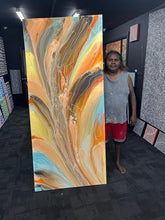 Load image into Gallery viewer, Janice Stanley holding her Pantu Salt Lake painting in-studio, showing its size and rich desert-inspired palette.
