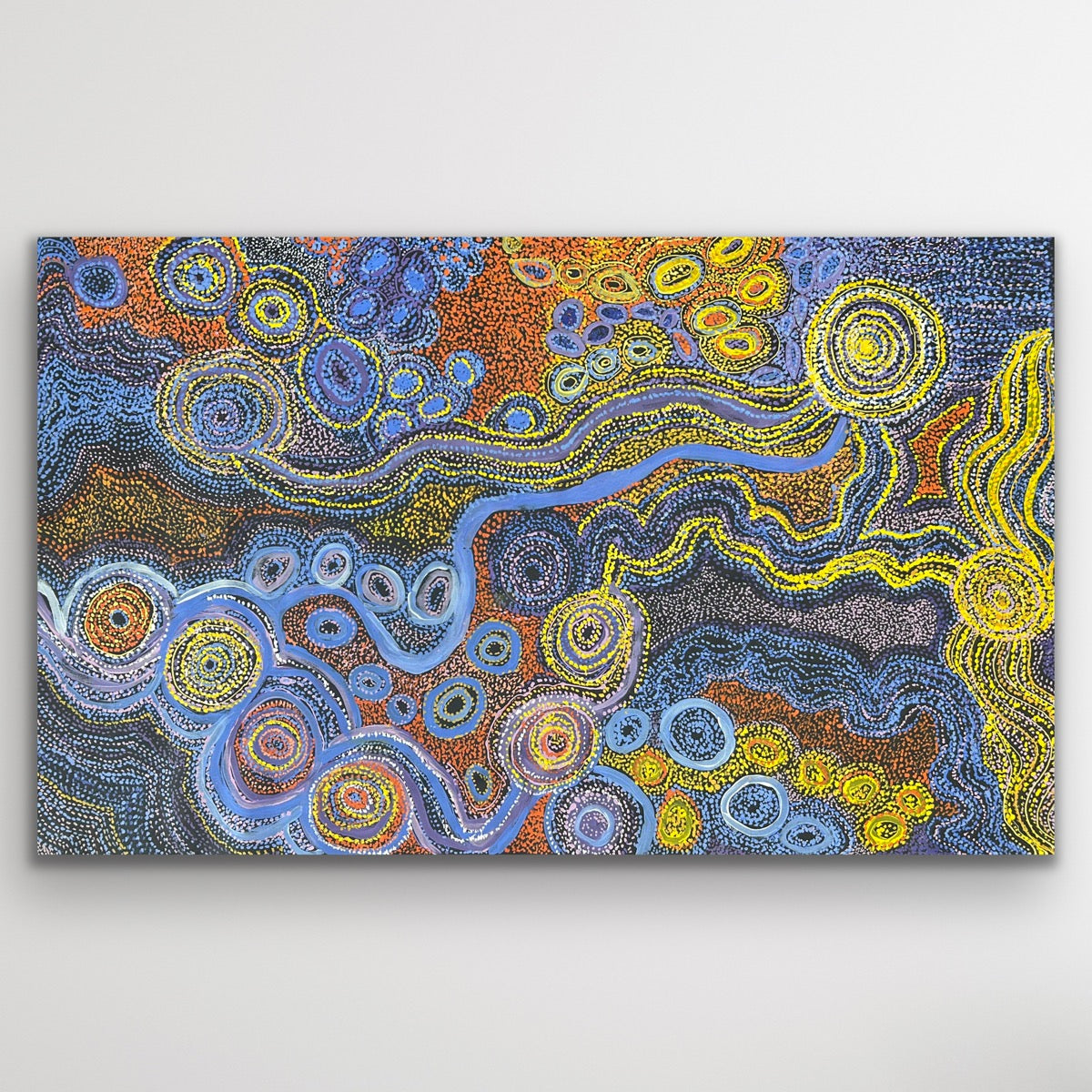 Rich blues and desert gold tones flow across the canvas in Rhoda Tjitayi’s depiction of the sisters’ Dreaming story.