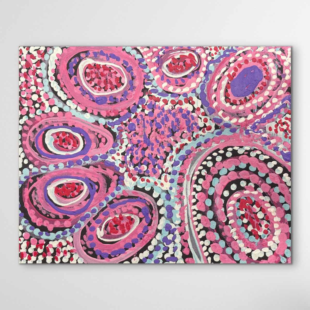 Colorful dot artwork with pink, purple, and black circles on a white background